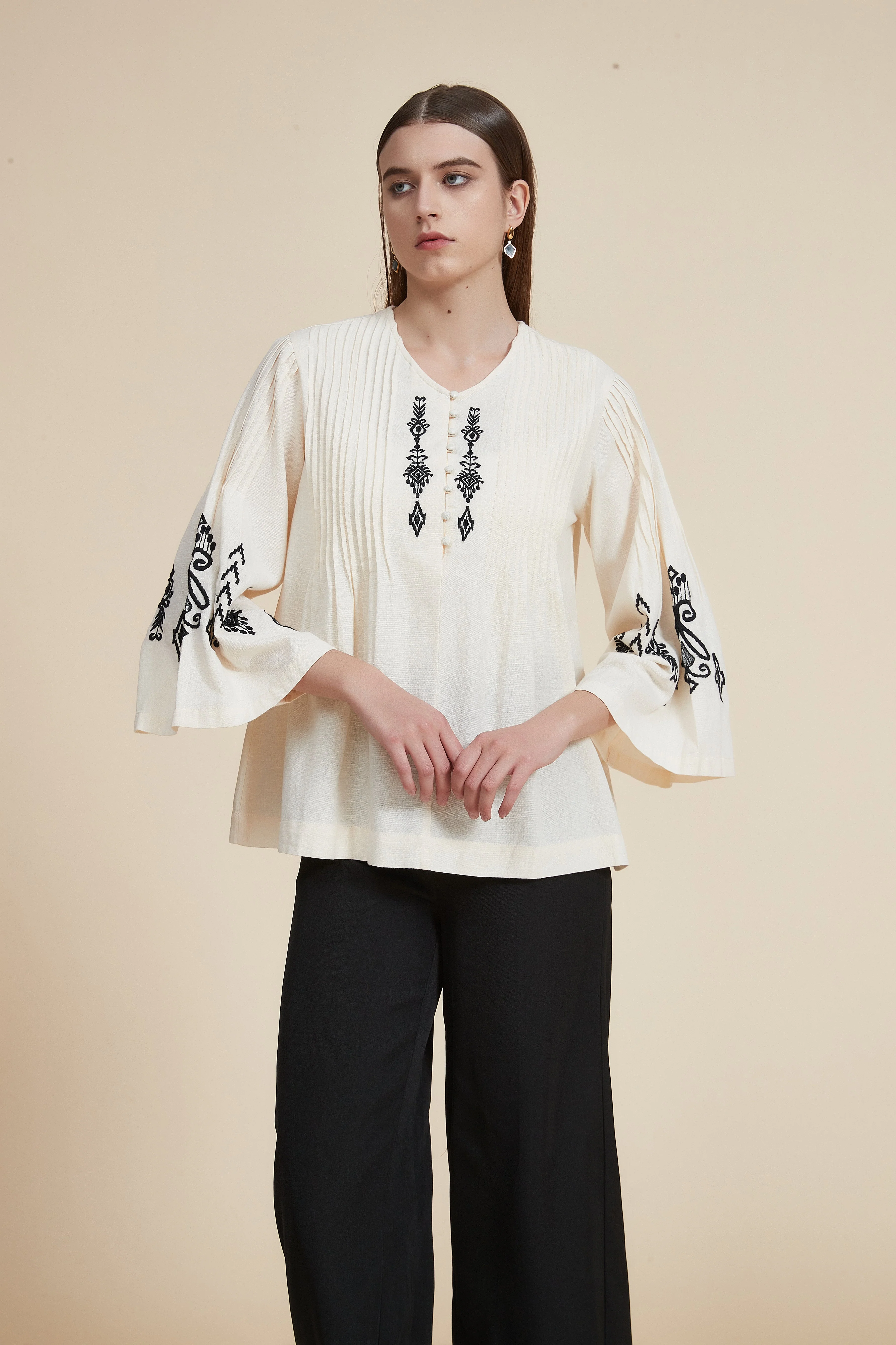 Pleated blouse with wide sleeves